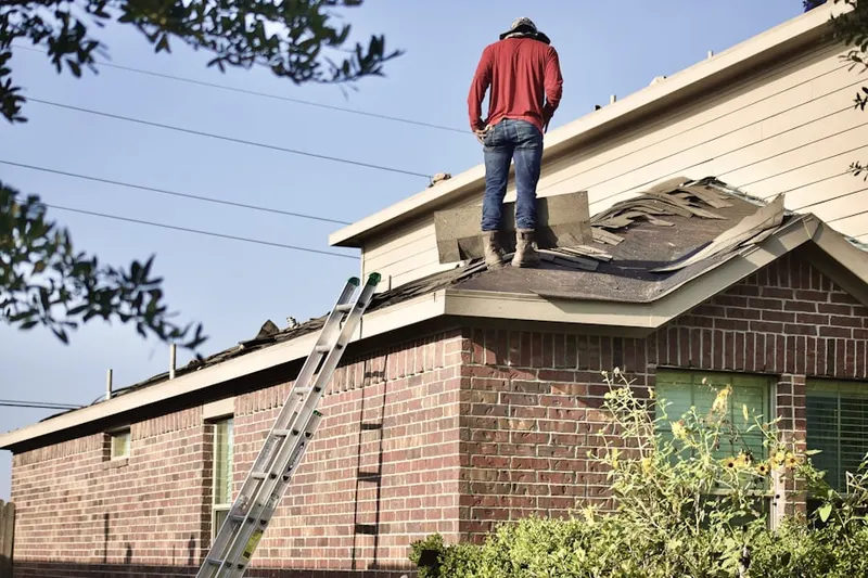 Professional roofer working on a residential roof in Port Gardner